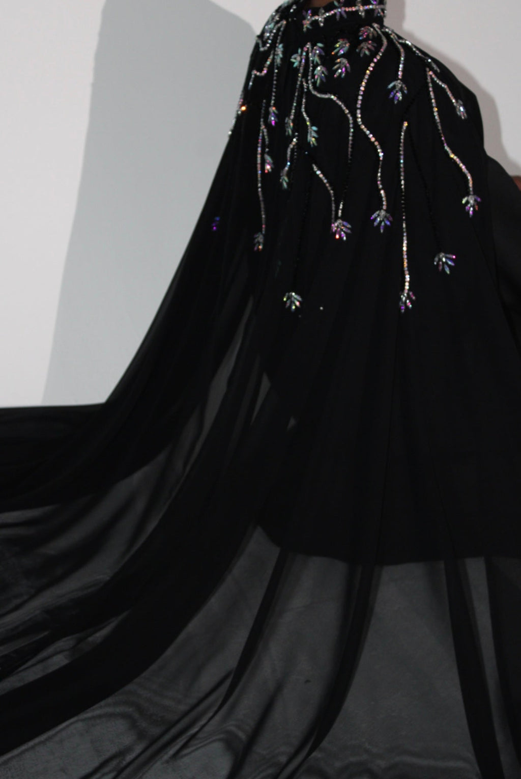 Black abaya with floral embroidery on a plain background