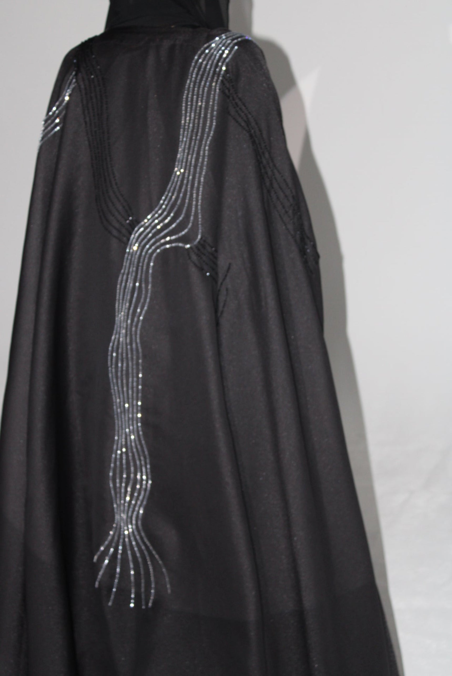 Black luxury abaya with silver thread design on a white background