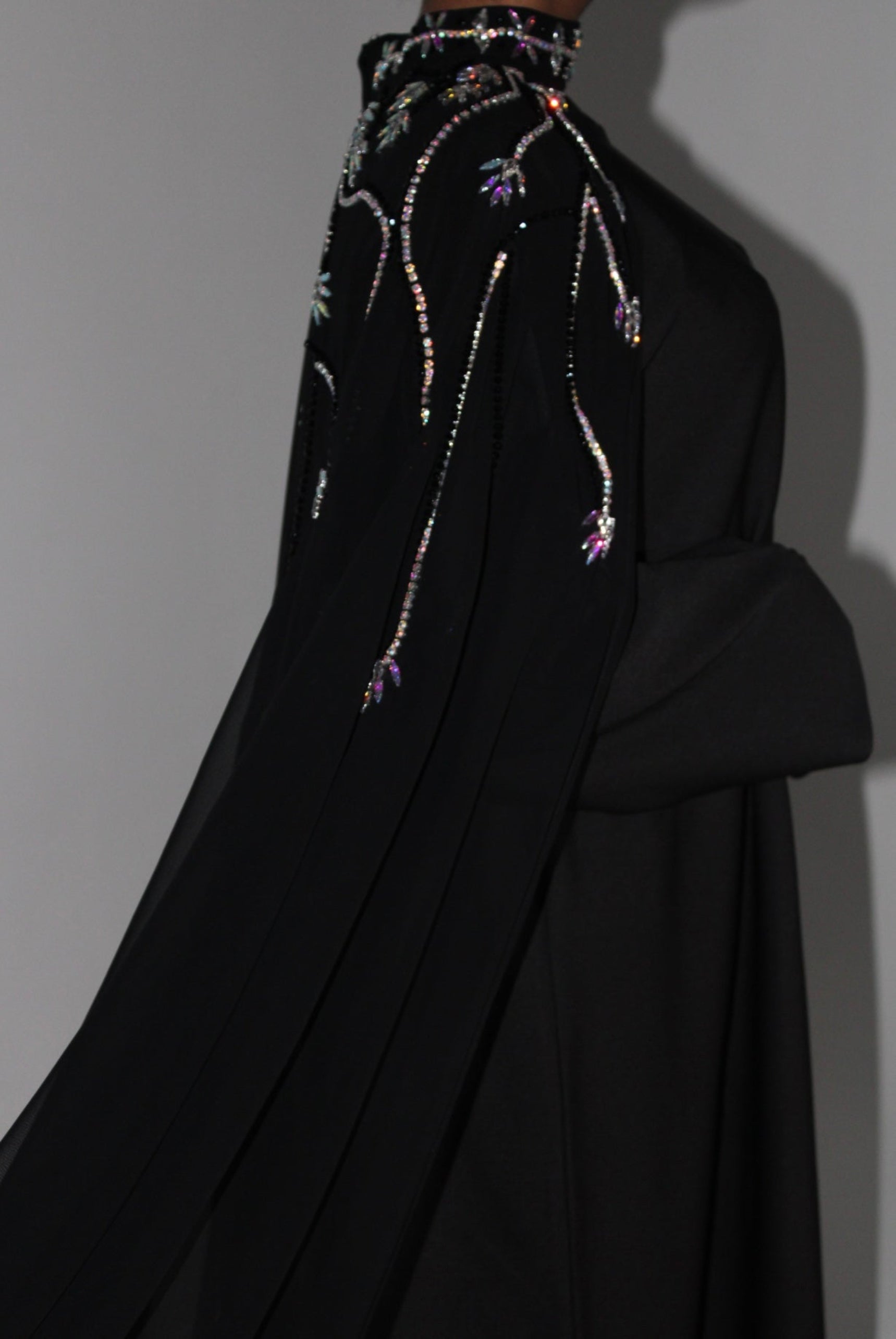 Black abaya embroidered garment on a plain background