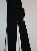 Load image into Gallery viewer, Black abaya with a high slit and decorative cuffs on a white background
