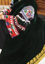 Load image into Gallery viewer, Traditional embroidered garment with colorful patterns on a dark background
