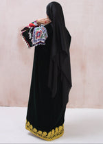 Load image into Gallery viewer, Black traditional outfit with colorful embroidery on a light background
